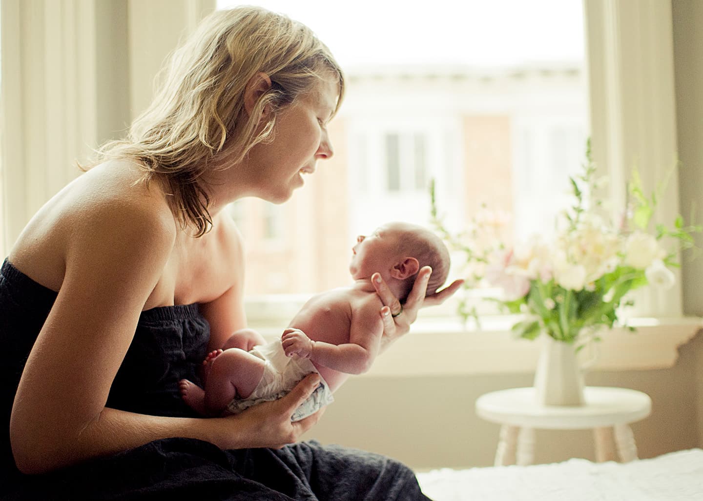 Mother holding and looking lovingly at her baby